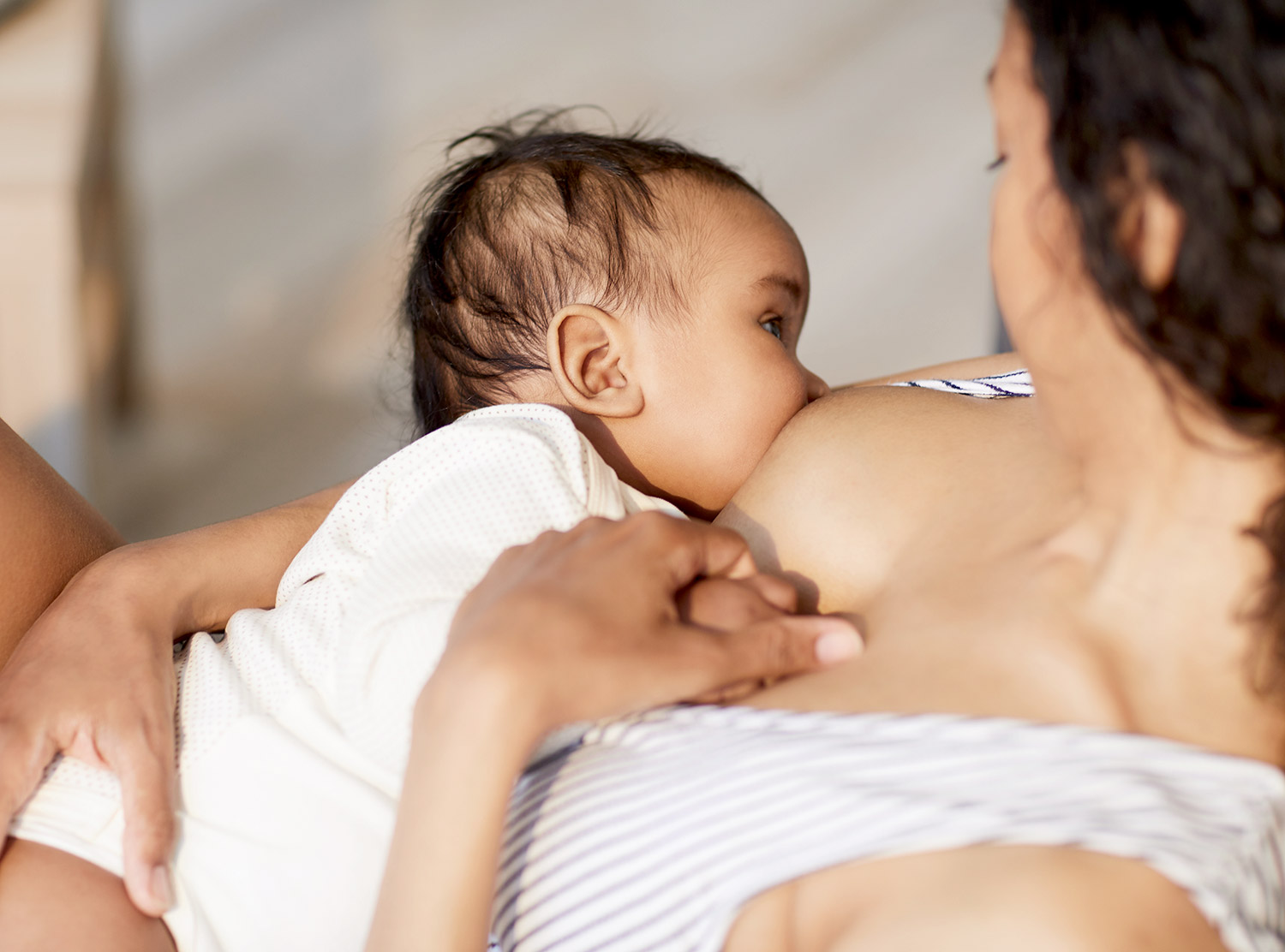Feeding Baby’s Microbiome: How Does Breastfeeding Influence The Gut-Brain Axis? Mother breastfeeding her baby