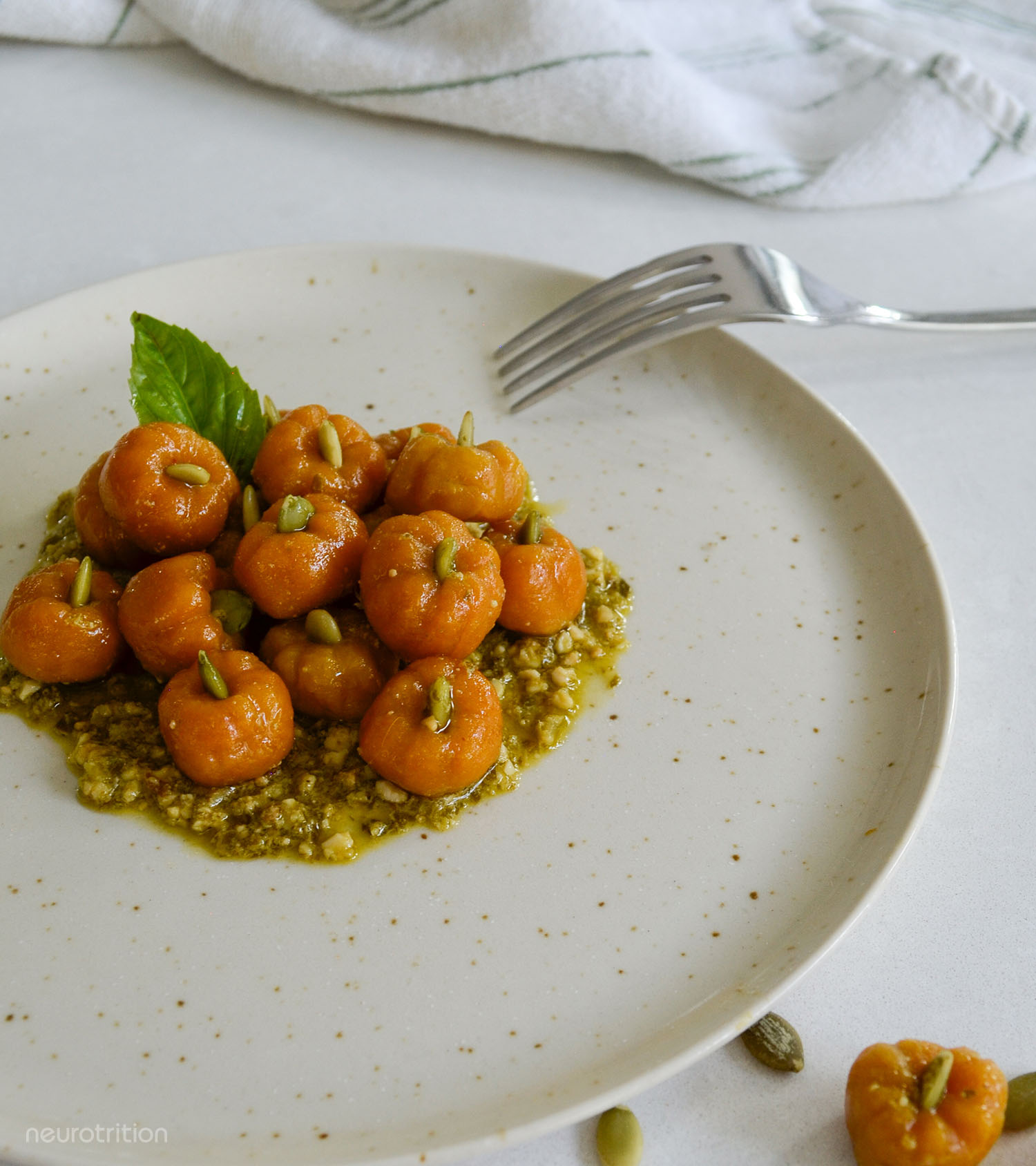 Pumpkin Pasta Plate of pumpkin-shaped orage pasta on a bed of pesto.